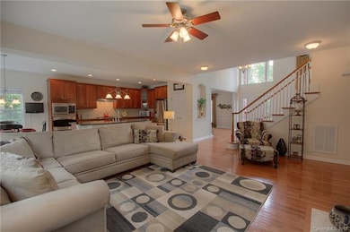 View of great room to kitchen, staircase & front f