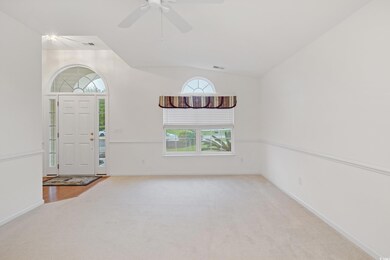 Entrance foyer featuring carpet flooring, lofted c