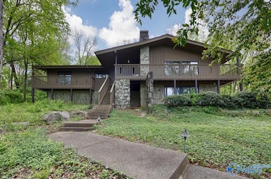 This MCM lodge style home on 1.8 acre treed lot close to downtown Huntsville, AL