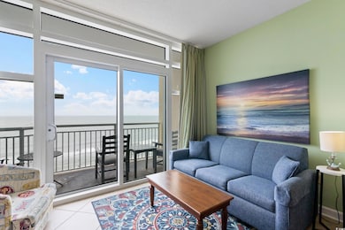 Living room featuring a water view, tile patterned flooring, and a textured ceiling