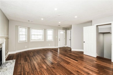 Unfurnished living room with a wealth of natural l
