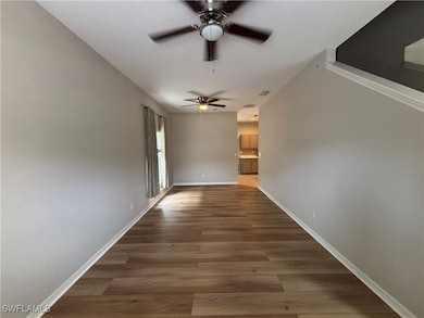 Unfurnished room with a ceiling fan and wood finis