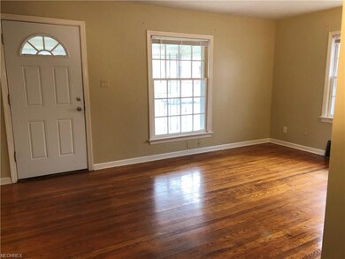 Living room with original oak floors and large win