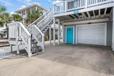 View of patio with stairs, a garage, concrete driveway, and a deck