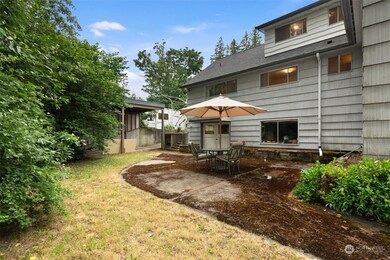 Peaceful backyard fenced along the back of the property for ultimate privacy. RV garage in the background.