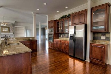 Huge eat-in kitchen with breakfast bar, granite counters & sophisticated slate back-splash. 