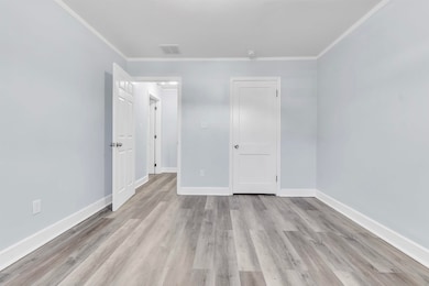 Unfurnished bedroom with light wood-style floors, 