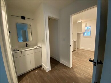 Bathroom featuring vanity, wood finished floors, 