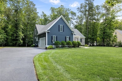 View of side of home featuring a garage and a yard