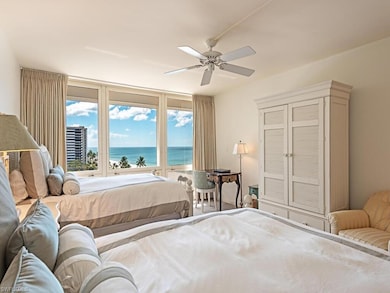 Bedroom with a water view and a ceiling fan