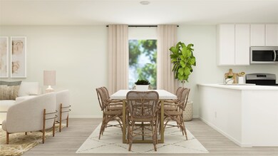 Dining area with light wood finished floors and baseboards