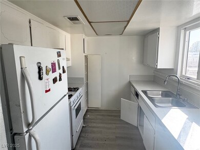 Kitchen with dark wood-style flooring, light count