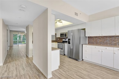 Kitchen with stainless steel appliances, backsplas