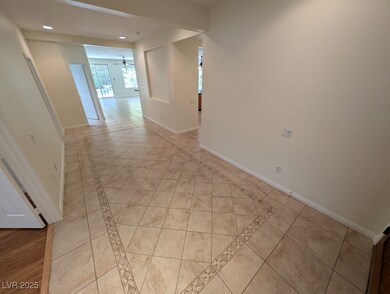 Hall with inlaid floor details, baseboards, recess