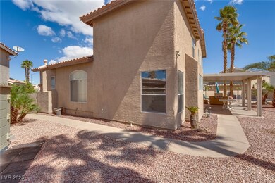 Back of property with stucco siding and a patio