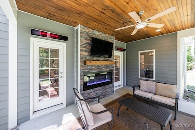 Fireplace with wood mantle, TV, ceiling Fan, ceili