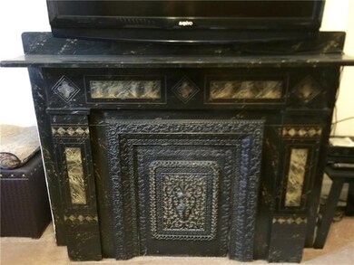 A gorgeous original decorative fireplace in the li