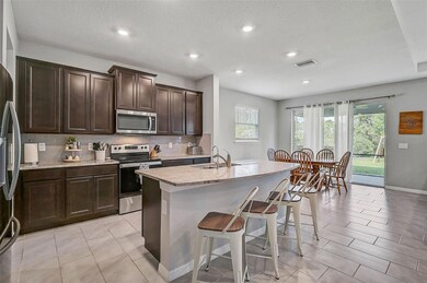 Kitchen with ample breakfast bar and dining area just beyond!
