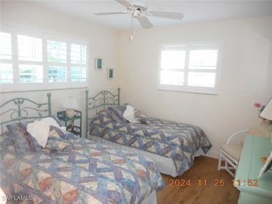Bedroom with wood finished floors and ceiling fan