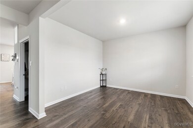 Spare room featuring dark wood finished floors and