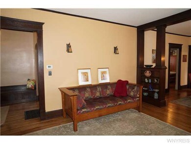 Living Room Living room with hardwood floors, book cases and a fireplace, Sconces on the wall as well adds character to this room!