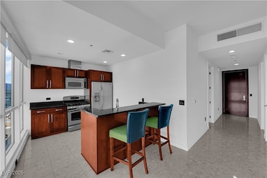 Kitchen featuring a kitchen bar, stainless steel appliances, recessed lighting, and a peninsula