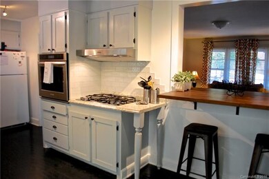 Newly renovated kitchen with gas cooktop, hood and
