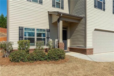 Property entrance featuring concrete driveway and 