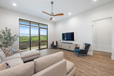 Living room with a ceiling fan, recessed lighting