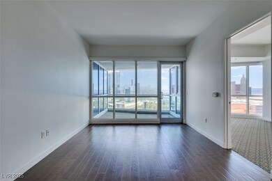 Unfurnished room featuring baseboards, dark wood-s