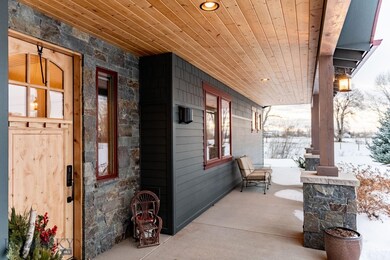 The exterior entails hardi-siding, stacked rock, a