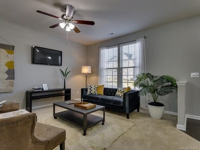 Large living space with ceiling fans throughout, 2