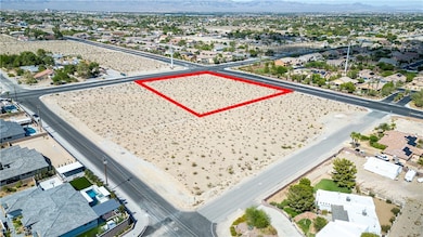 View of property location with a mountainous background and property boundaries highlighted