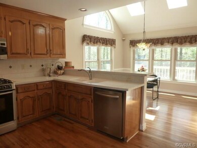 Kitchen with Corian countertops, vaulted ceilings 
