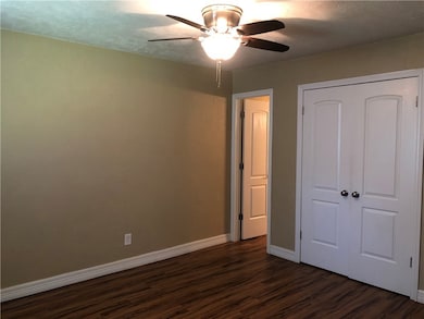 Unfurnished bedroom featuring dark wood-style floo