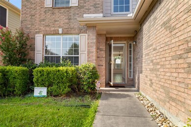 Property entrance featuring brick siding