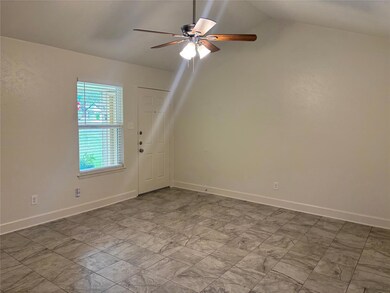 Spare room featuring ceiling fan, lofted ceiling,