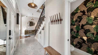 Beautiful foyer area with pendant lighting, ceramic tile floors, and easy access to the covered patio.