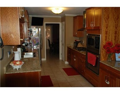 Kitchen. Granite counters, tile floor, custom cabi