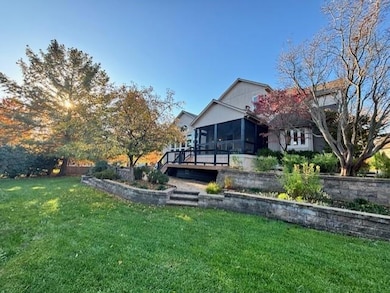 Beautiful backyard with screened in porch, deck and patio around landscaping
