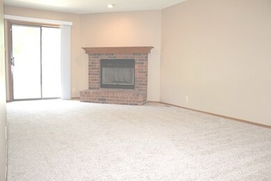 Living room has plenty of natural light, all brick