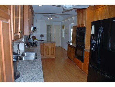 Kitchen New granite countertops, black appliances 