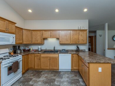 Kitchen with crown molding, gas stove and breakfas