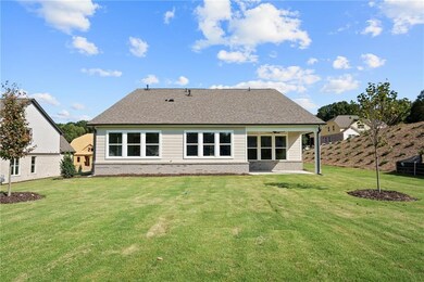 Back of property featuring a lawn