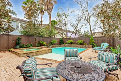 Lovely landscaping and trees surround this backyar