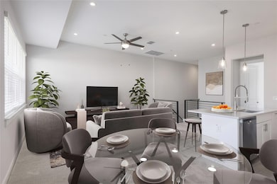 Dining space featuring light carpet, a ceiling fa