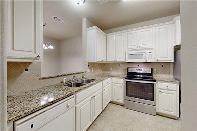 Kitchen featuring a sink, visible vents, decorativ