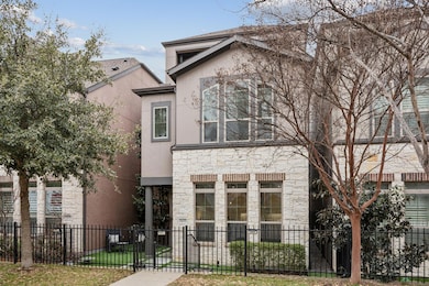 View of front facade with stone siding, a fenced f