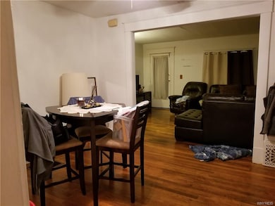 Unit 1, open dining room to living room, beautiful hardwood floors.