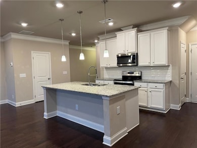 Kitchen featuring a sink, appliances with stainles